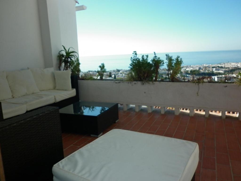 a living room with a couch and a view of the ocean at El Capistrano Sur in Nerja