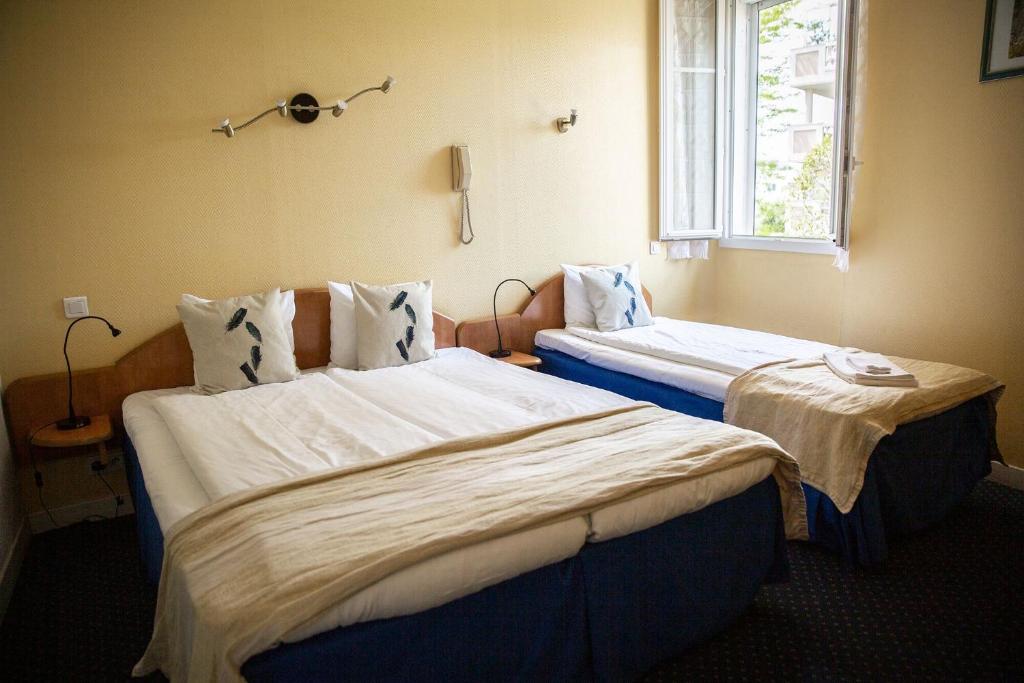 Postel nebo postele na pokoji v ubytování Hôtel Du Soleil