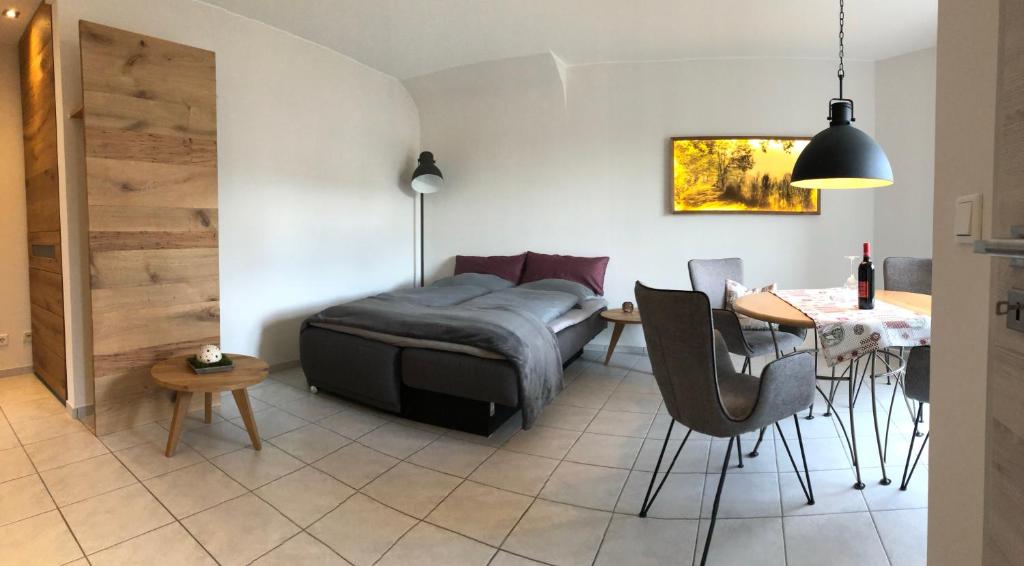 a living room with a bed and a table and chairs at An den Bergwiesen in Winterberg