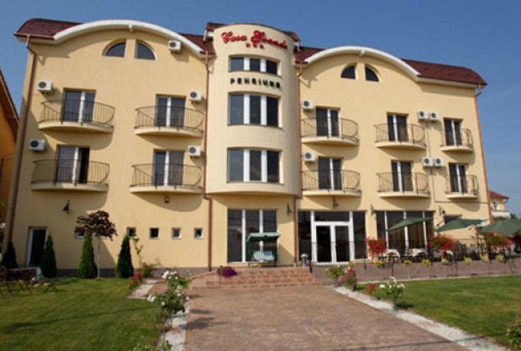 a large yellow building with balconies on it at Pension Casa Grande in Baile Felix