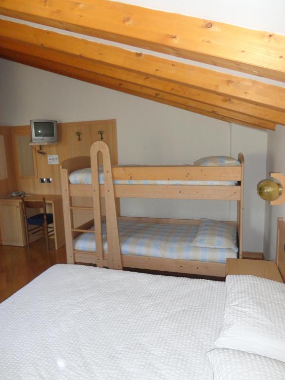 Postel nebo postele na pokoji v ubytování Hotel Al Caminetto