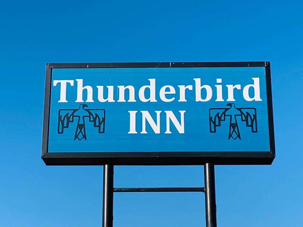 a blue sign with the words thunderbird im at Thunderbird Inn in Liberal