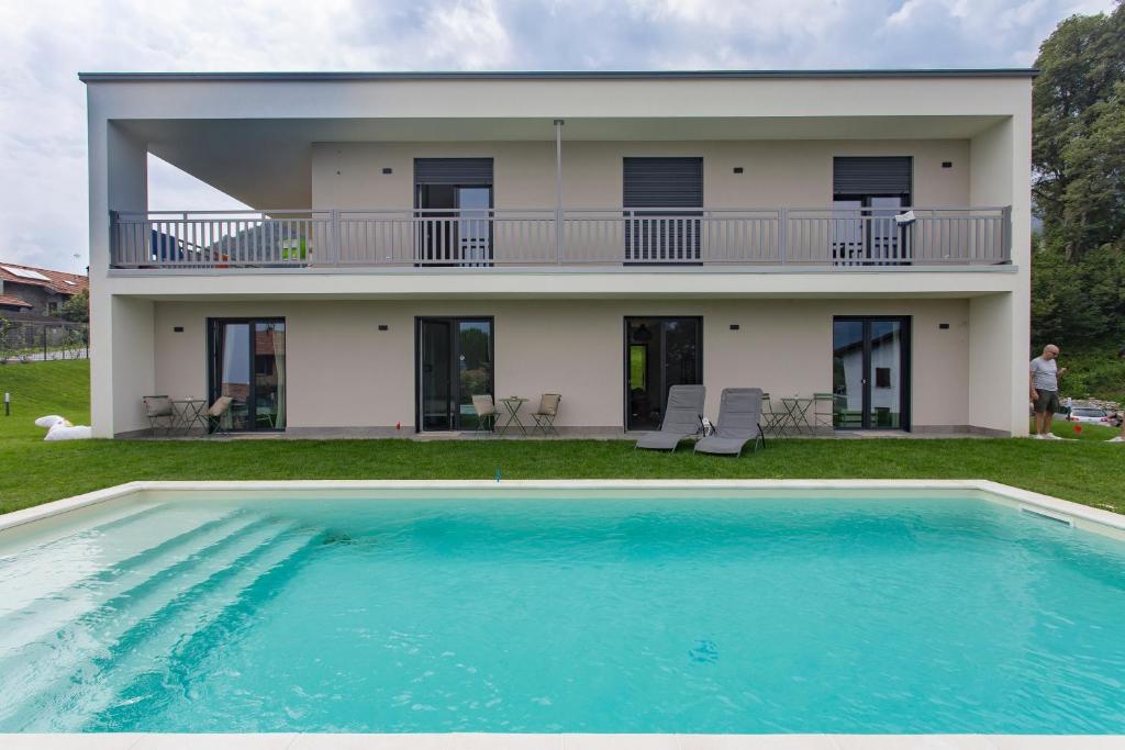a villa with a swimming pool in front of a house at Aqua&Co Bellagio - B&B with love in Bellagio