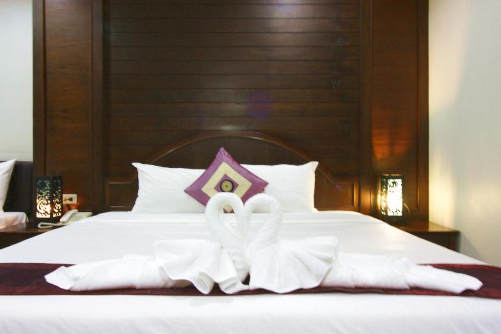 Postel nebo postele na pokoji v ubytování Baan Veerakit Hotel