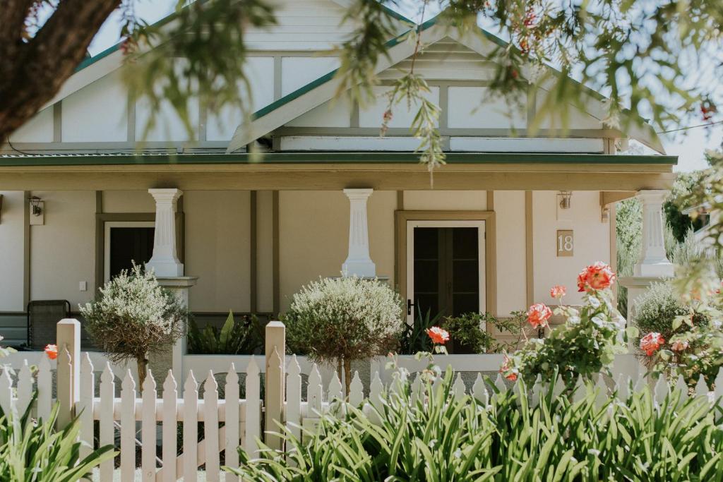 a white picket fence in front of a house at A Market Place Mudgee in Mudgee