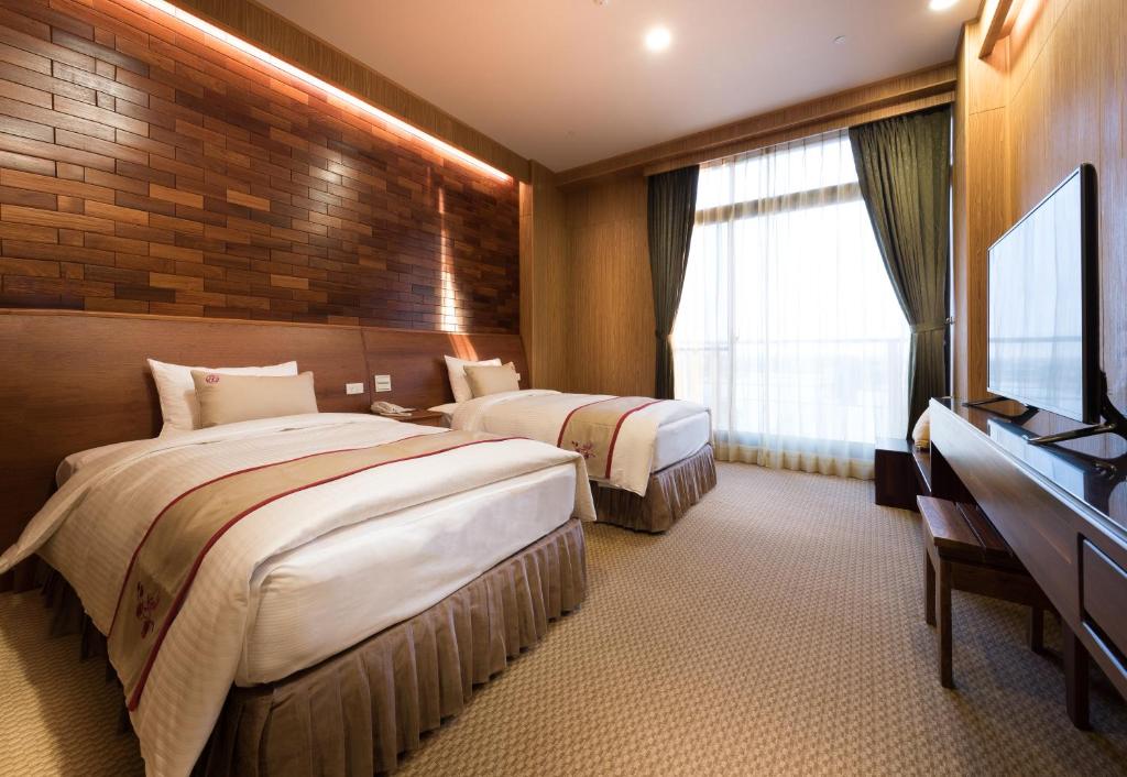 Postel nebo postele na pokoji v ubytování Shandori Hotel