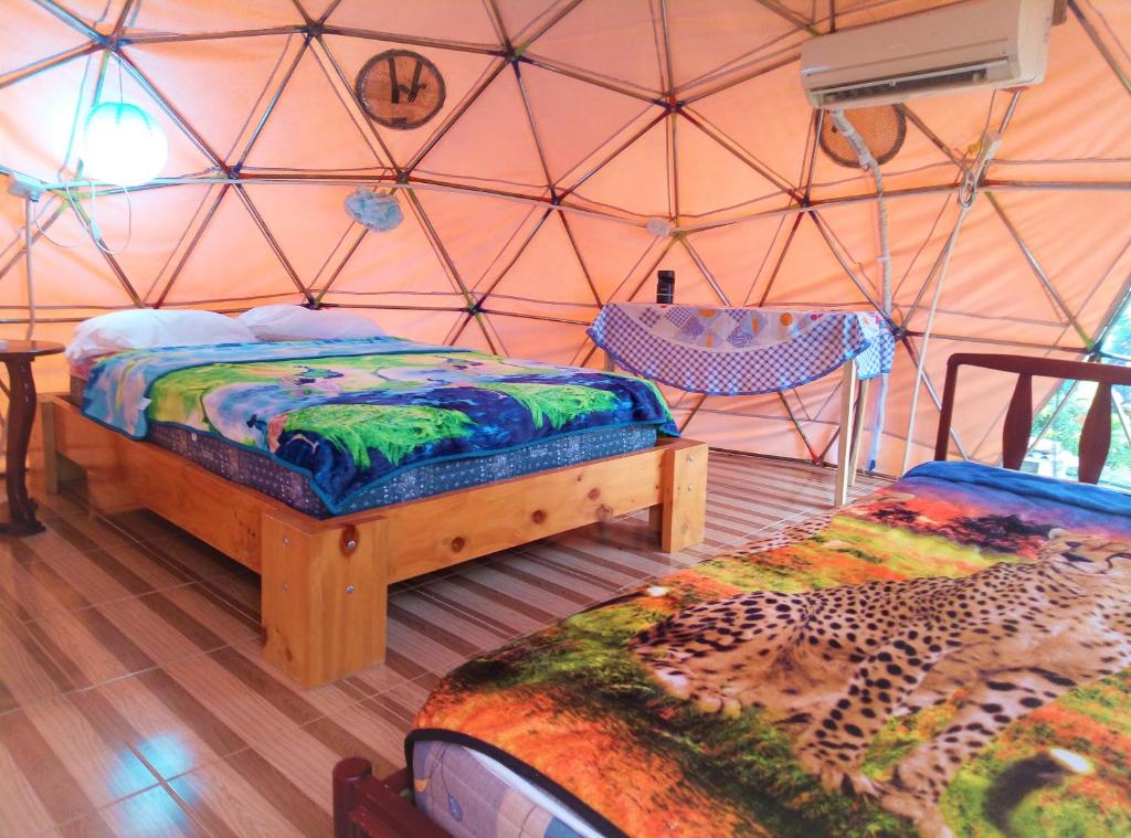 a room with two beds in a tent at Nativa Whale Domes in Puerto López