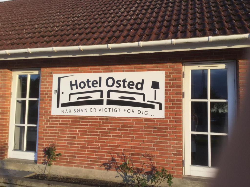 a hotel used sign on the side of a brick building at Hotel Osted in Lejre