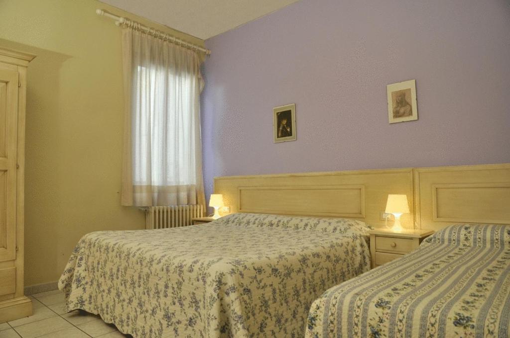 Postel nebo postele na pokoji v ubytování Hotel Regina