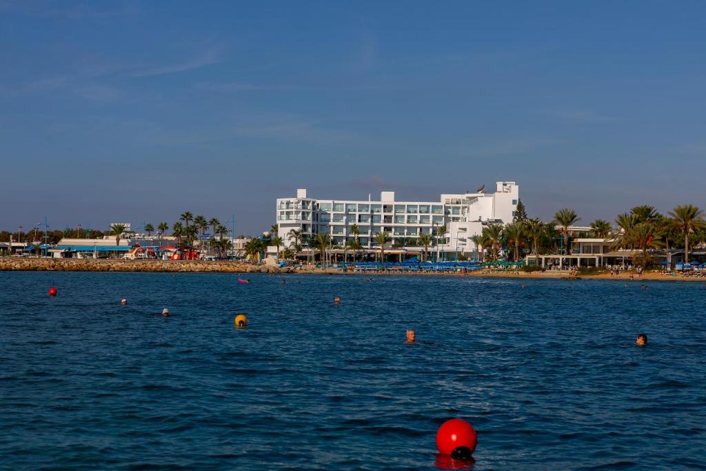 a large body of water with a building in the background at Limanaki Beach Hotel & Suites in Ayia Napa