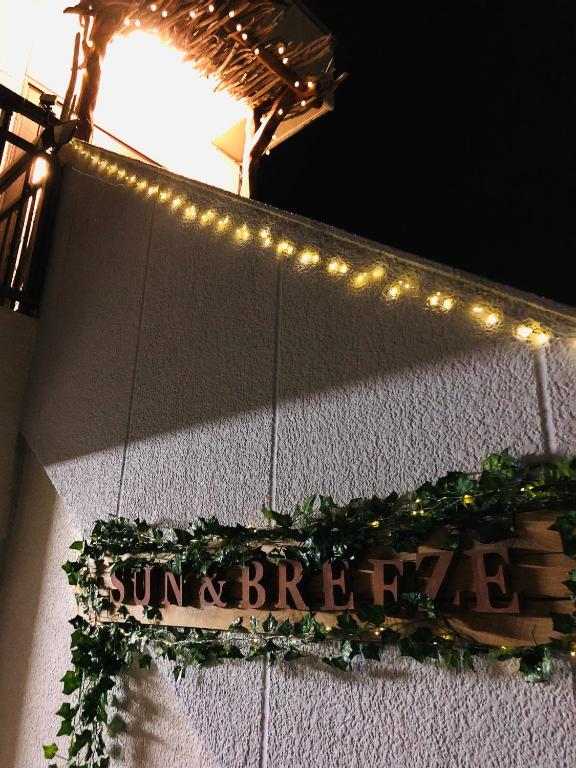 a sign on the side of a building with lights at 一棟貸しの海宿 Kamakura SUN&BREEZE in Kamakura