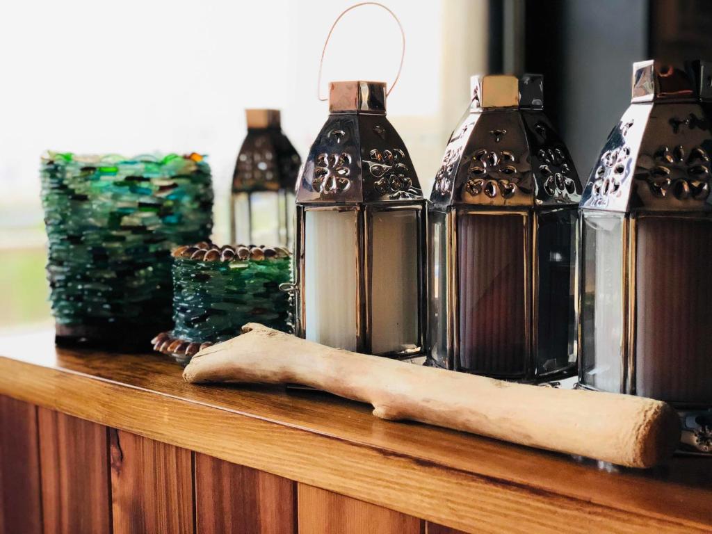a wooden table topped with bottles and a paper sidx sidx sidx at 一棟貸しの海宿 Kamakura SUN&BREEZE in Kamakura