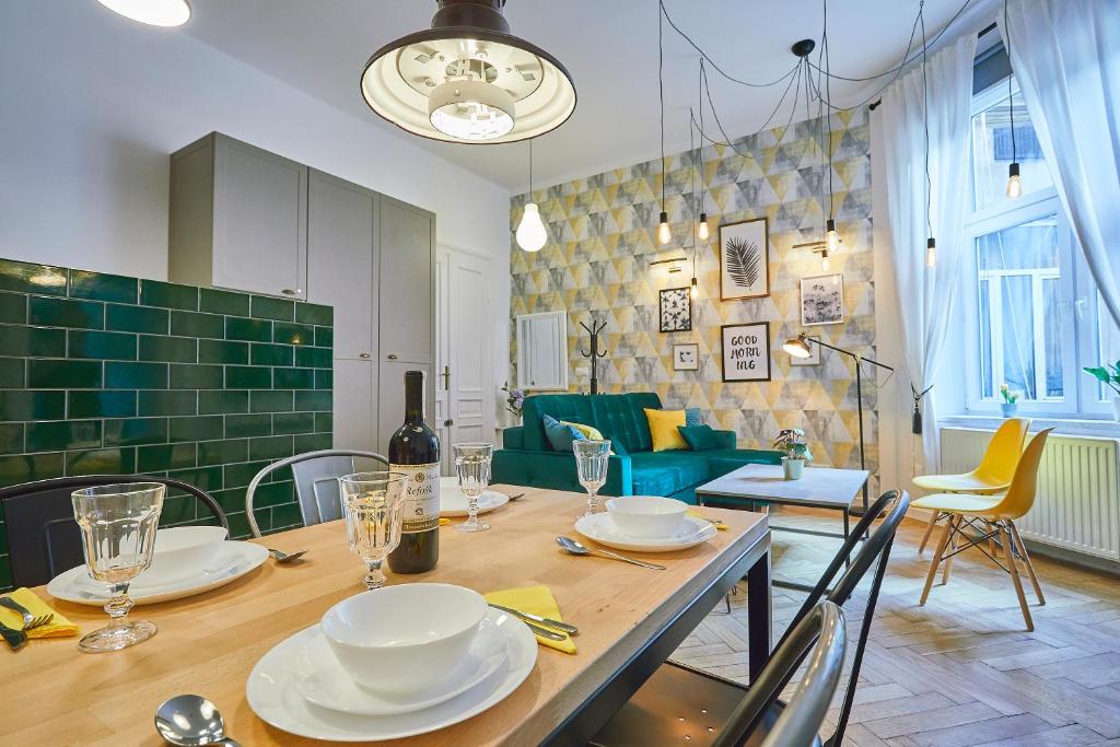 jadalnia ze stołem z talerzami w obiekcie Kurkowa GamaHome Cozy Apartments w Krakowie