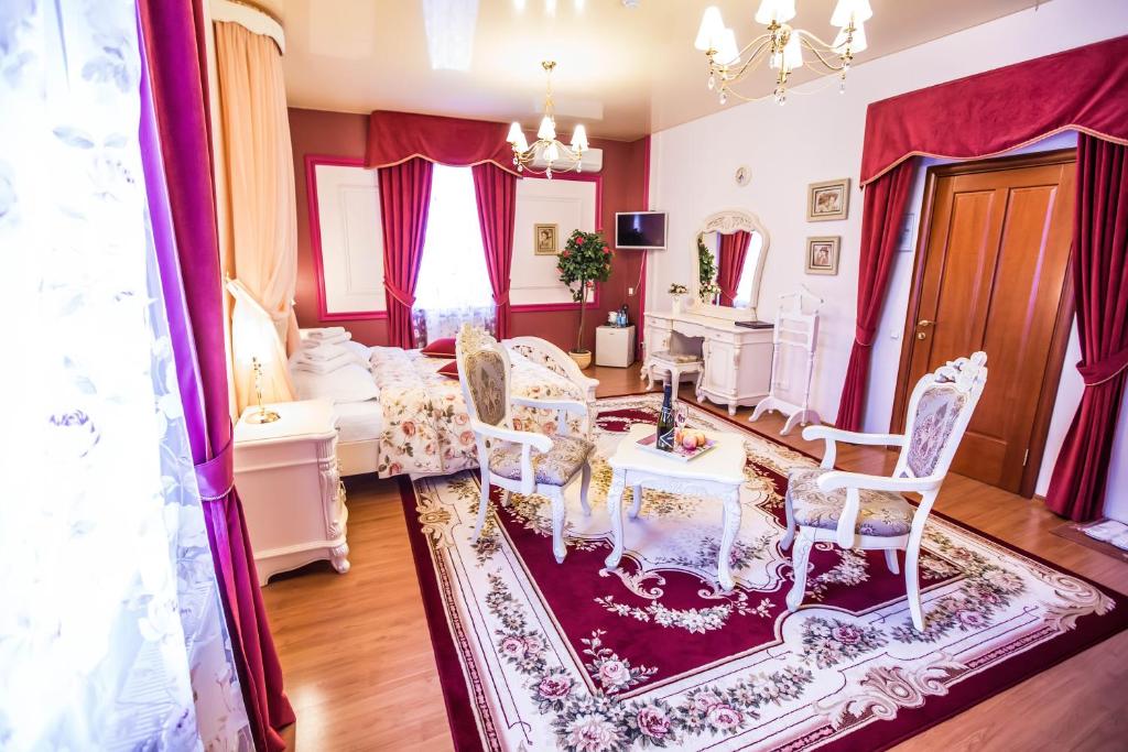 a living room with a table and chairs at 13 Chairs Boutique Hotel in Petrozavodsk