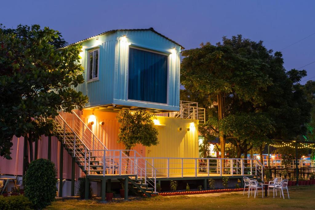 a house with a staircase on the side of it at The G Snoozebox in Udaipur