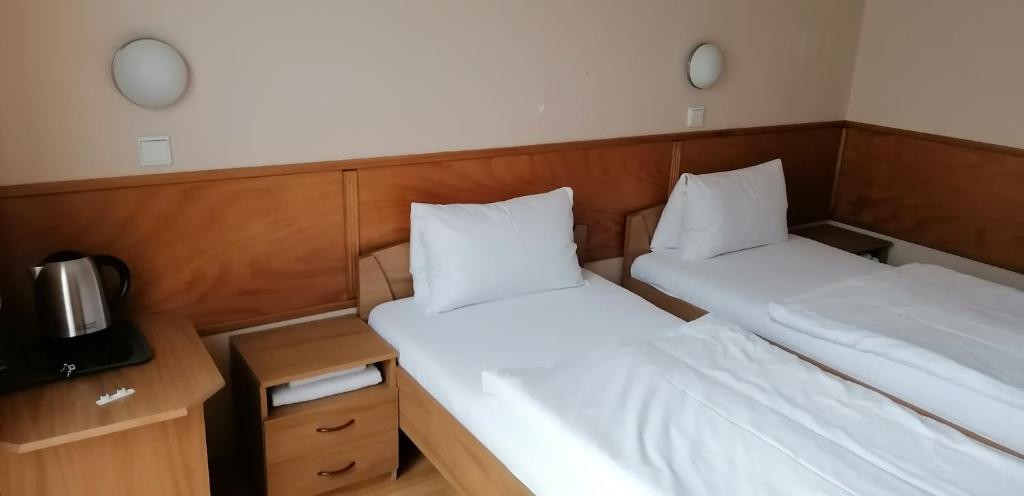 Postel nebo postele na pokoji v ubytování Pension Magnolia