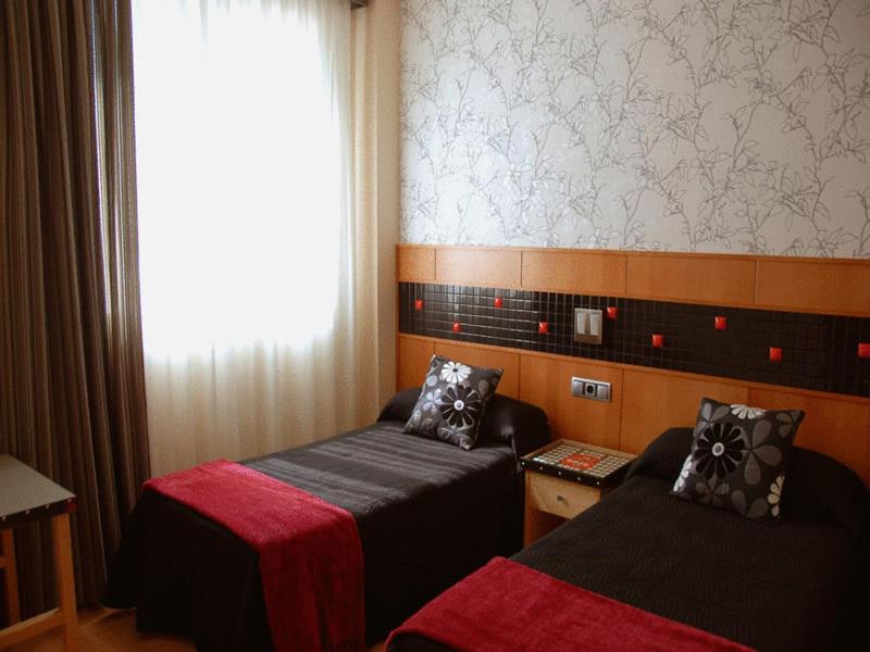 Cama o camas de una habitación en Hostal de Cuenca
