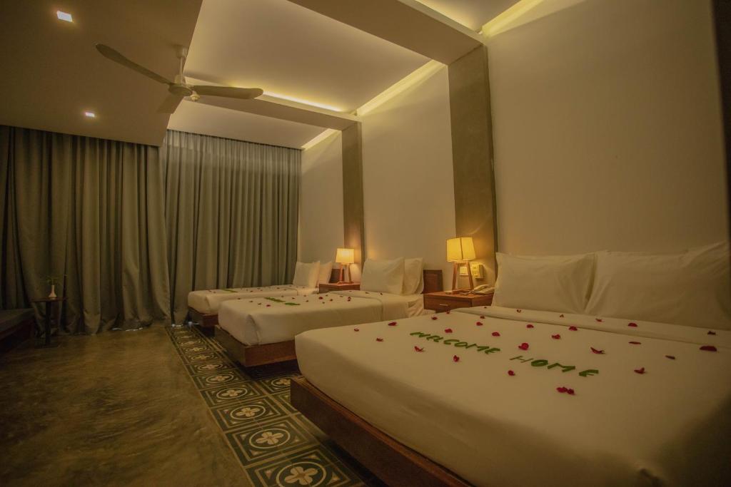 Postel nebo postele na pokoji v ubytování Tanei Angkor Resort and Spa