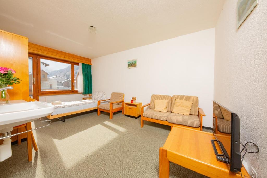 TV a/nebo společenská místnost v ubytování Haus Boccalino