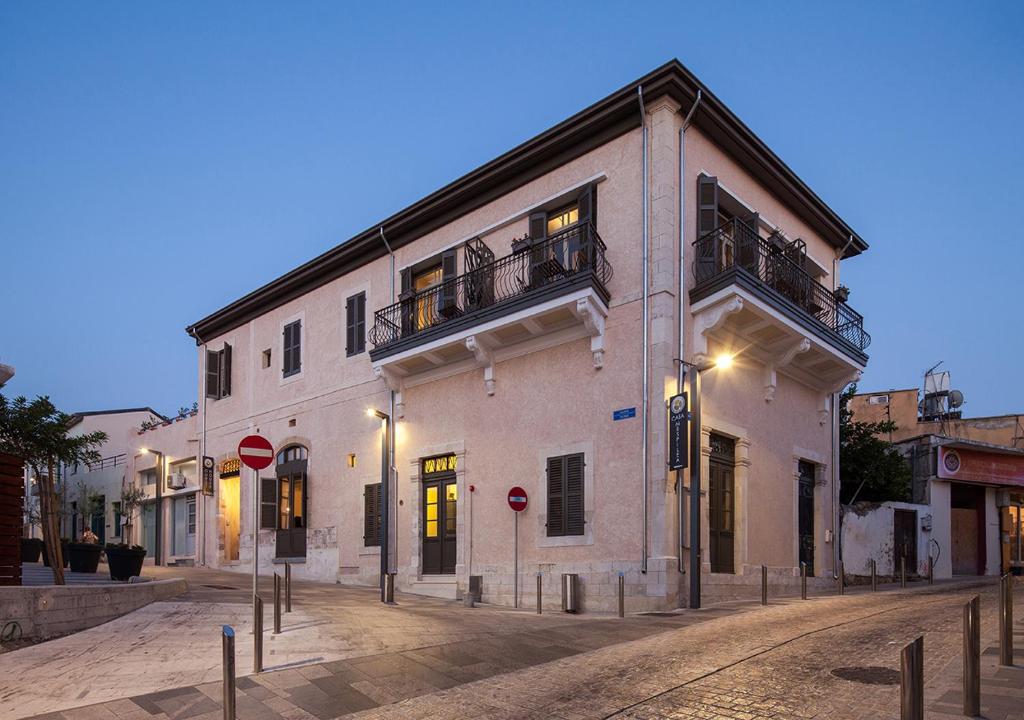 a large white building on a city street at night at Casa Mespilea in Paphos City