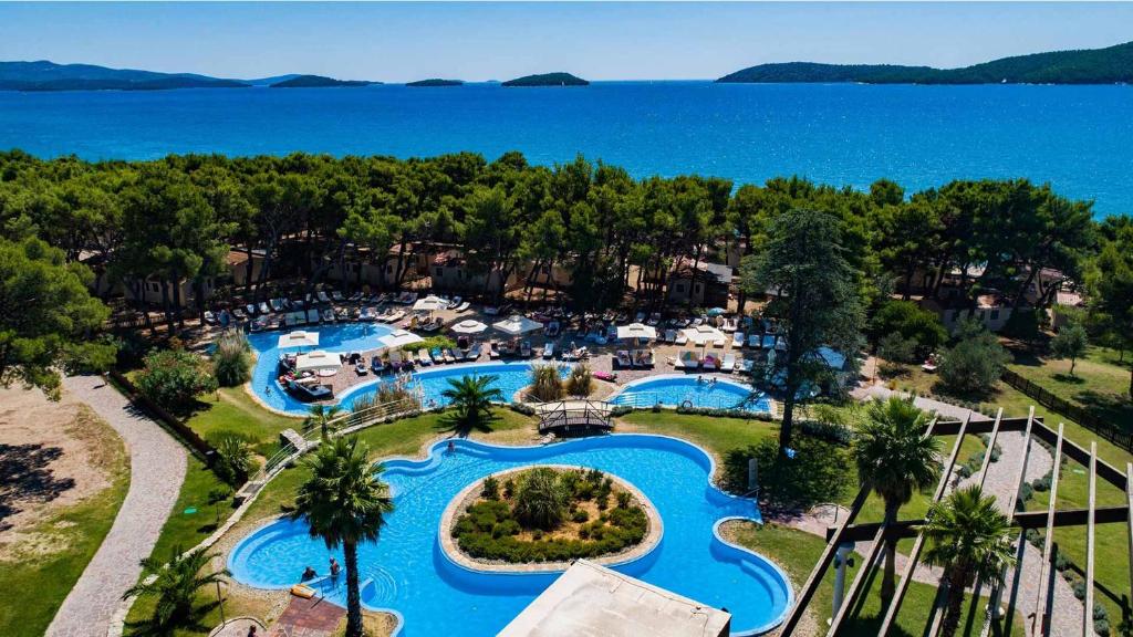 an aerial view of a resort with two swimming pools at Amadria Park Beach Hotel Niko in Šibenik