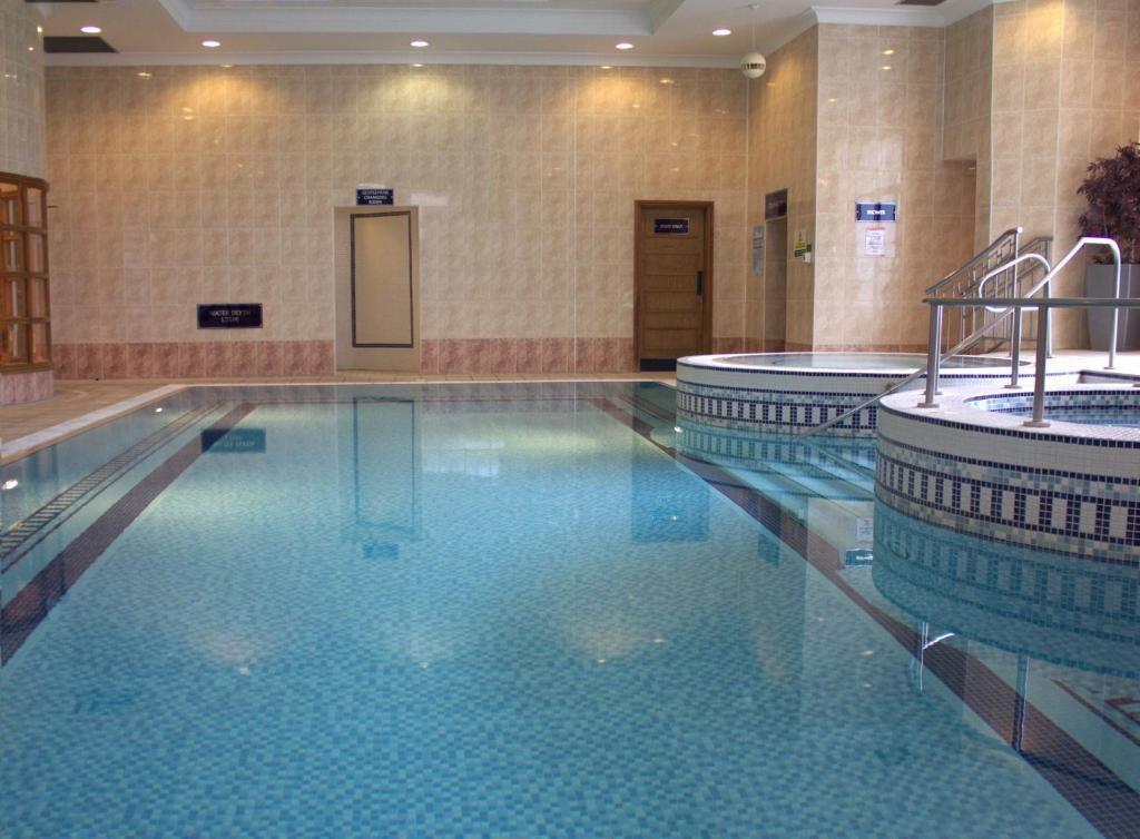 a pool in a hotel with two swimming pools at The Aberdeen Altens Hotel in Aberdeen