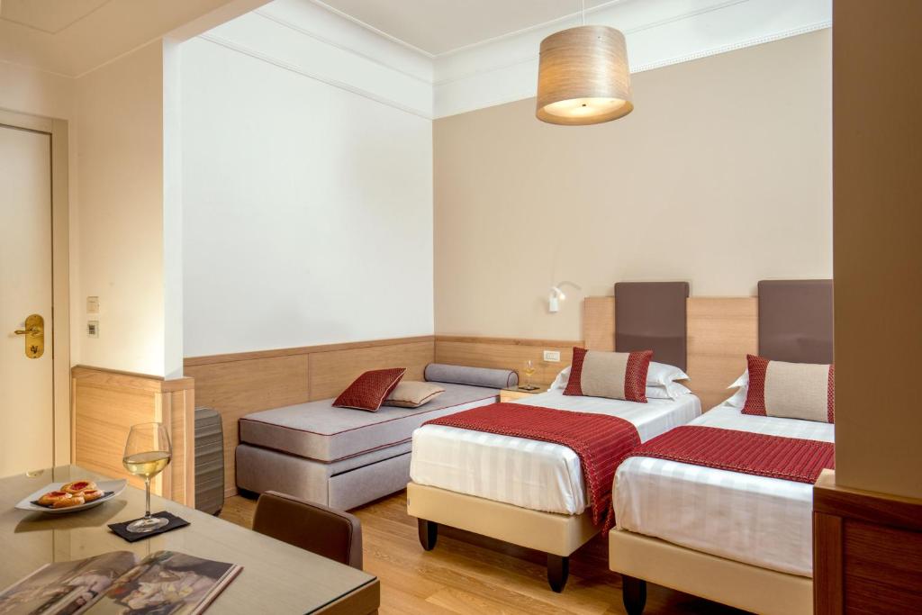 Postel nebo postele na pokoji v ubytování Hotel Nord Nuova Roma