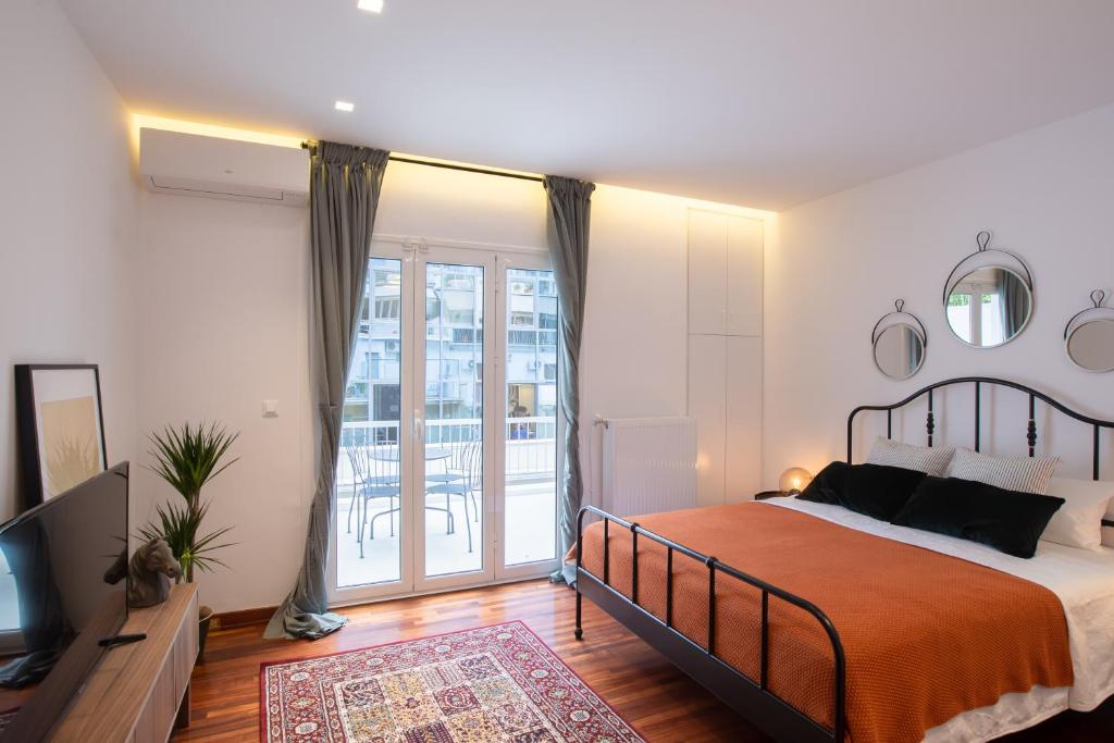 - une chambre avec un lit, une télévision et un balcon dans l'établissement Phaedrus Living: City Centre Luxury Flat Mavromichali, à Athènes