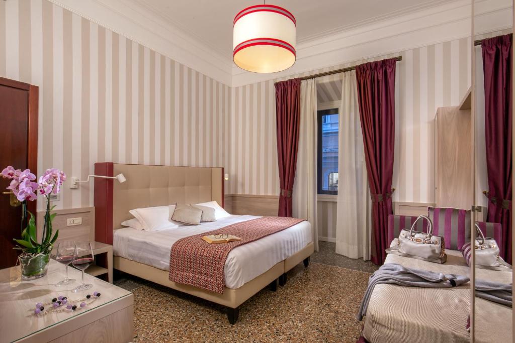 Postel nebo postele na pokoji v ubytování Hotel Nord Nuova Roma
