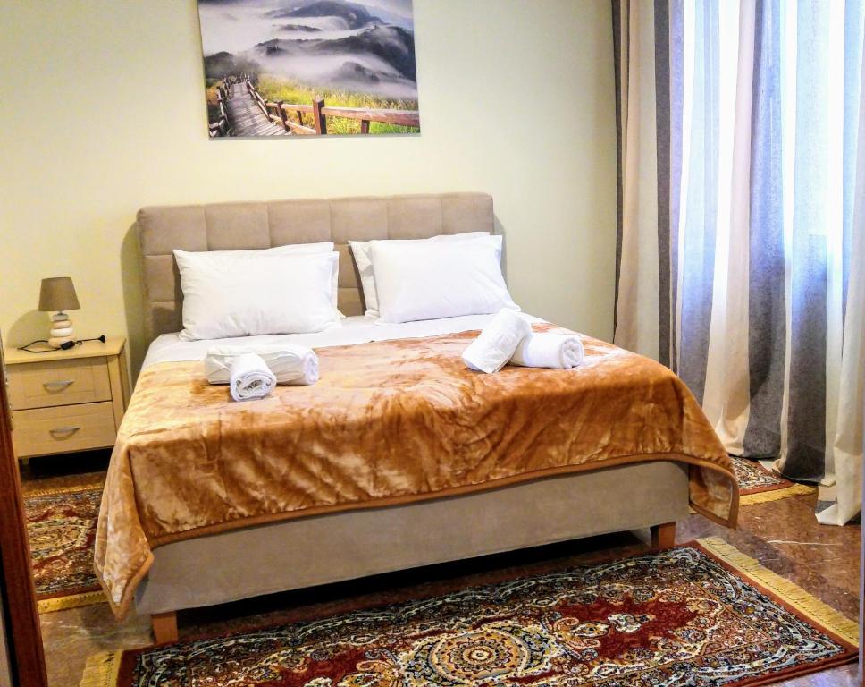 a bedroom with a bed with two towels on it at Delphic Horizons in Delphi