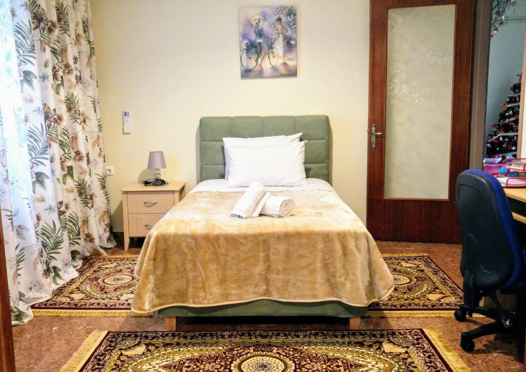 a bedroom with a bed with two towels on it at Delphic Horizons in Delphi
