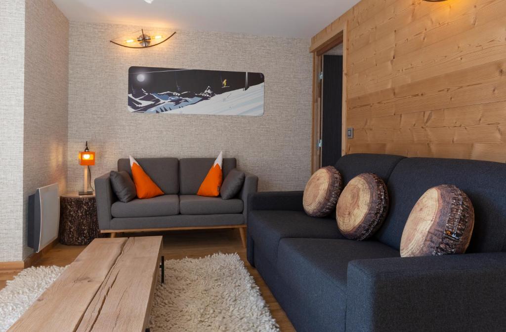 a living room with a couch and a table at Hotel Base Camp Lodge - Bourg Saint Maurice in Bourg-Saint-Maurice