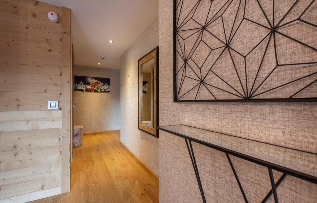 a hallway of a house with a wall at Hotel Base Camp Lodge - Bourg Saint Maurice in Bourg-Saint-Maurice