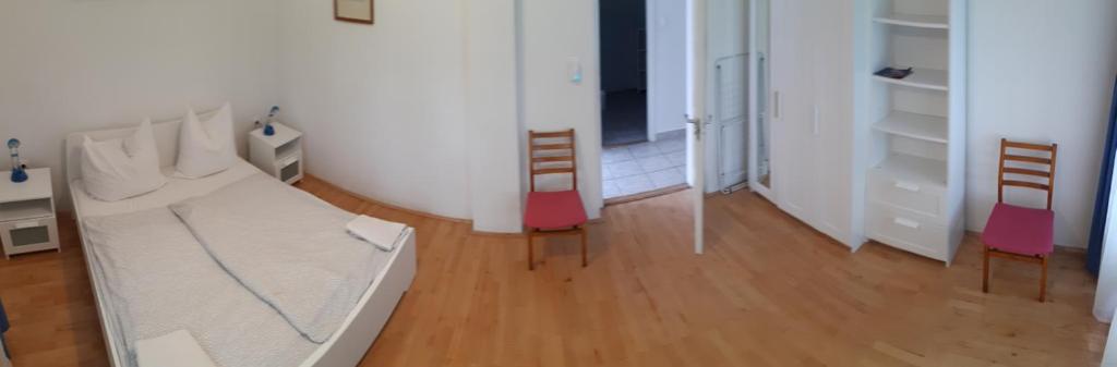 Postel nebo postele na pokoji v ubytování Jankó Apartman