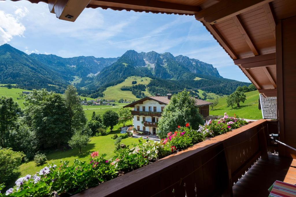 a view from the balcony of a house with flowers at Ferienhof Auerhof in Walchsee