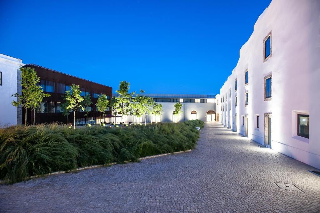 an empty alley between two buildings with plants at Pestana Cidadela Cascais - Pousada & Art District in Cascais