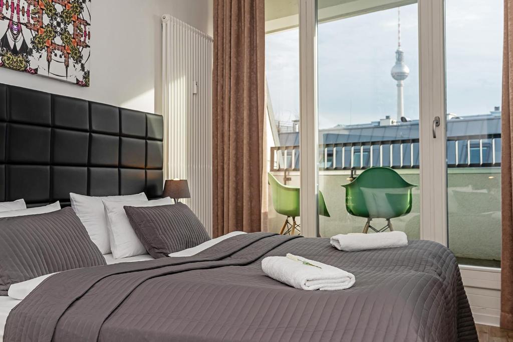 a bedroom with a large bed with two towels on it at Apartments Rosenthal Residence in Berlin