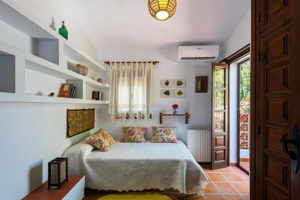 Postel nebo postele na pokoji v ubytování Villa Cortijo del Peñón