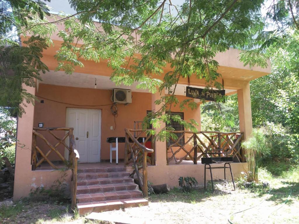 a house with stairs leading to the front door at Cabaña Luna de Pueblo in Salta