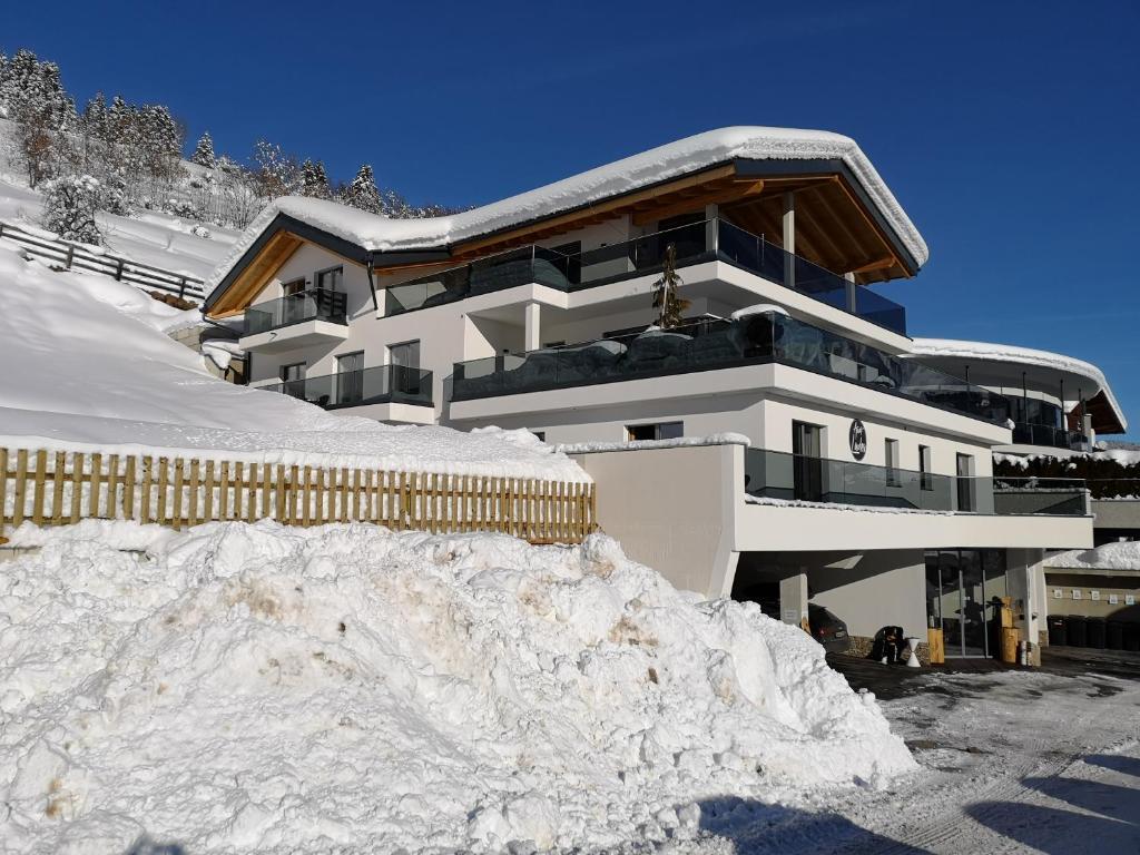 a building with a pile of snow in front of it at Apart Laudes in Ladis