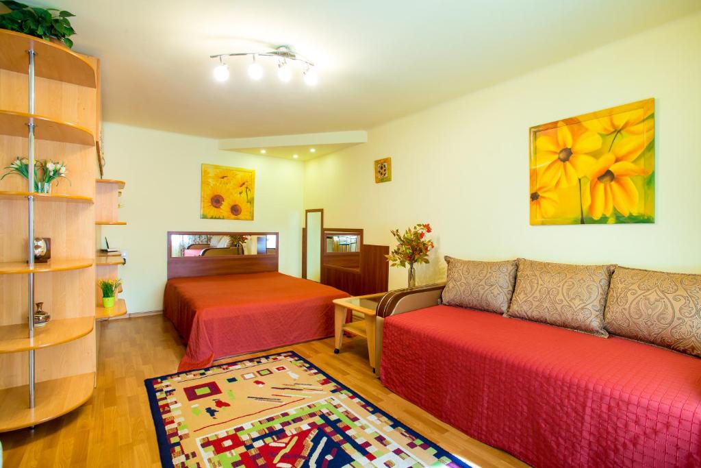 a living room with two beds and a couch at Cozy Apartment on Pugachev Lane in the City Center in Kherson