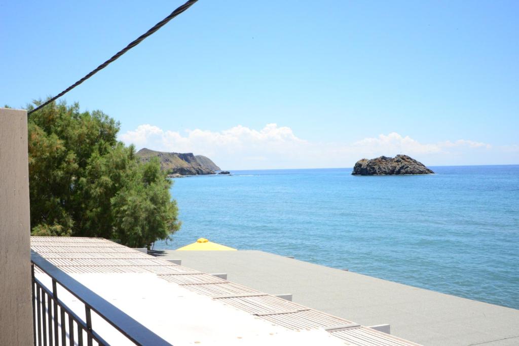 a view of the ocean from the balcony of a house at Sappho Hotel in Skala Eresou