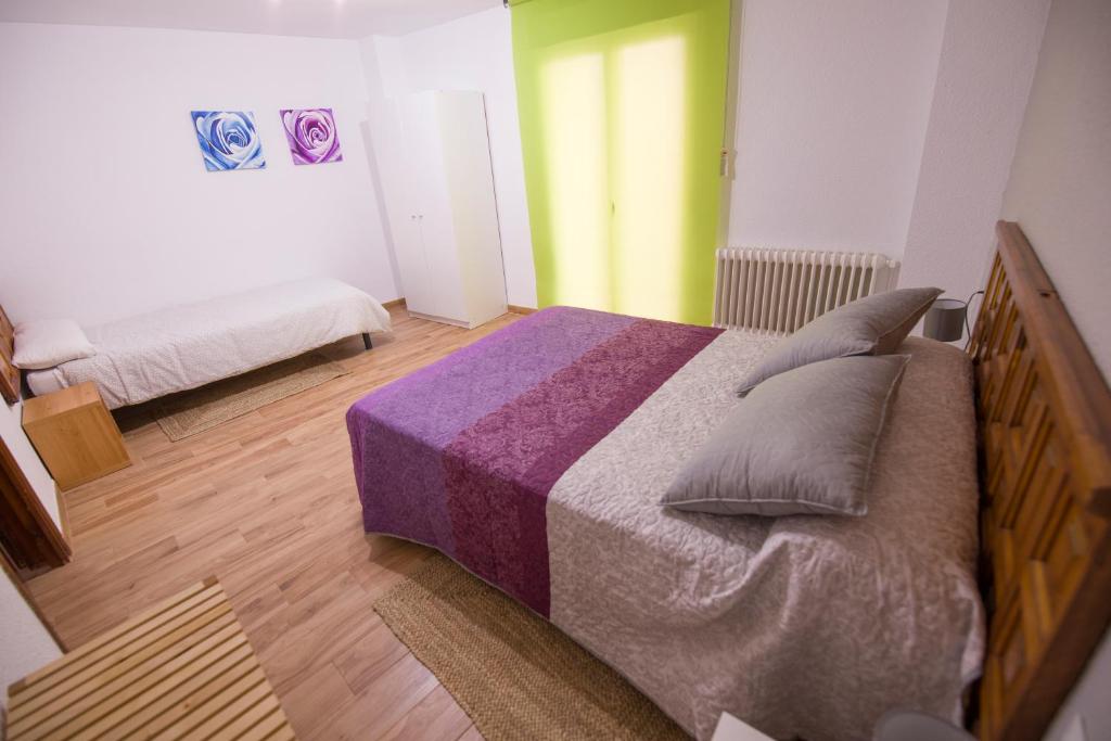 a bedroom with a large bed with pillows on it at Casa Manzana in Morella