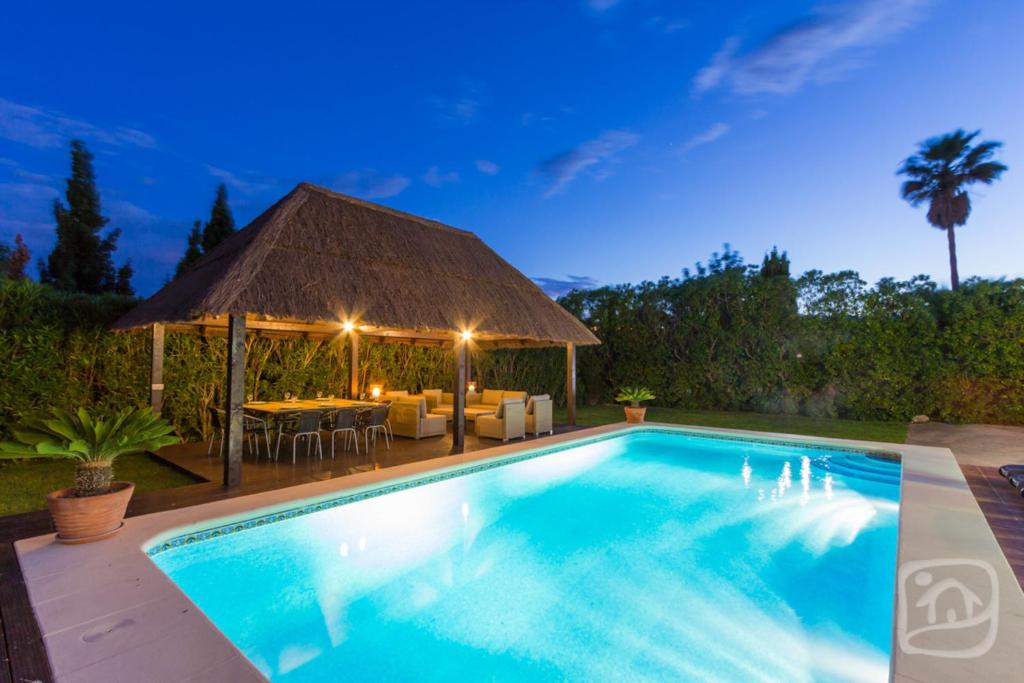 a swimming pool with a gazebo at Villa Isla by Abahana Villas in Benissa