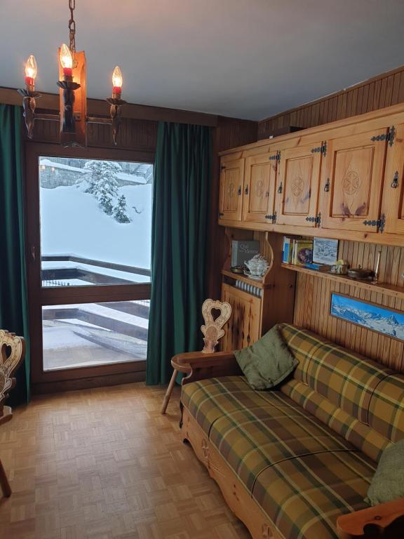 a bedroom with a bed and a sliding glass door at Una Finestra sul Cervino - CIR Valtournenche 0117 in Breuil-Cervinia