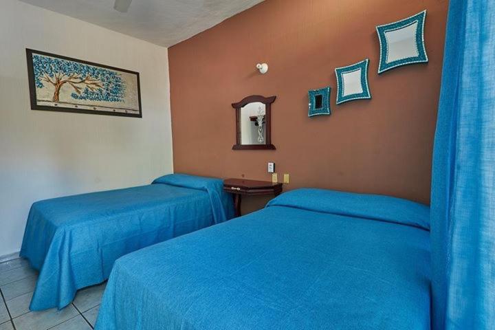 מיטה או מיטות בחדר ב-Hotel Posada San Rafael