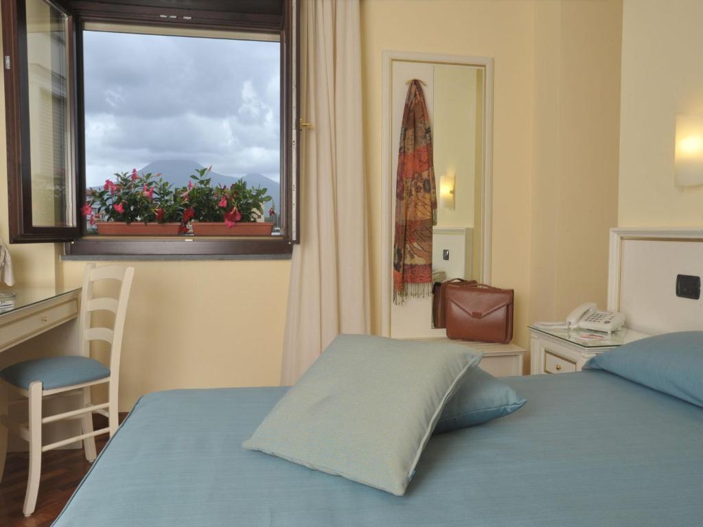 Postel nebo postele na pokoji v ubytování Costa Hotel