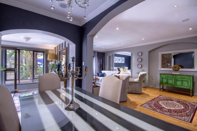 a living room with a dining table and a living room at Roads End in Benoni
