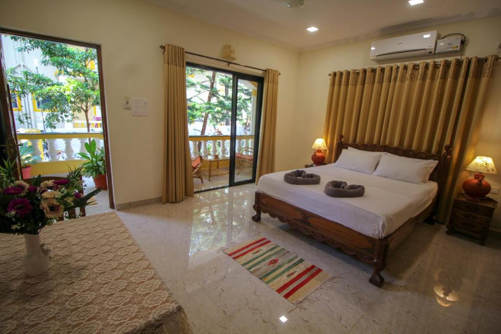 Postel nebo postele na pokoji v ubytování Primavera Holiday Homes-FAMILY RUN GOAN GUEST HOUSE