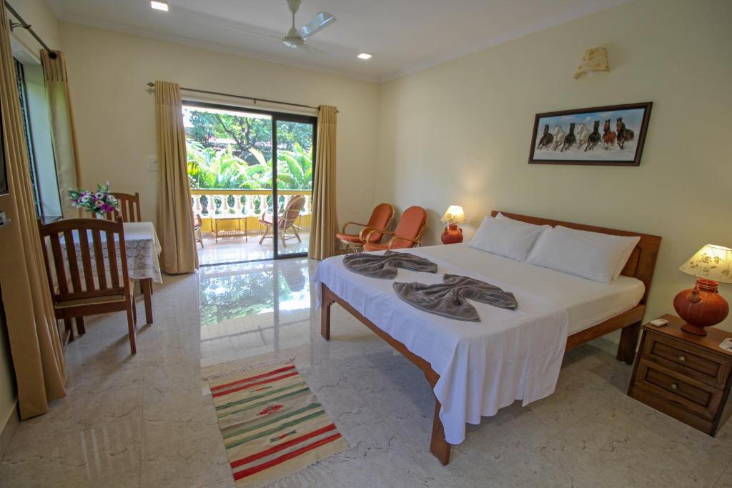 Postel nebo postele na pokoji v ubytování Primavera Holiday Homes-FAMILY RUN GOAN GUEST HOUSE
